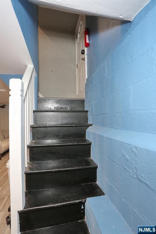 393 High St, Nutley, NJ 07110 - staircase featuring concrete block wall