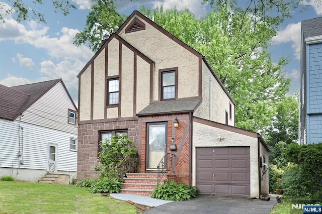 393 High St, Nutley, NJ 07110 - tudor-style house with entry steps, stucco siding, asphalt driveway, a front yard, and a garage