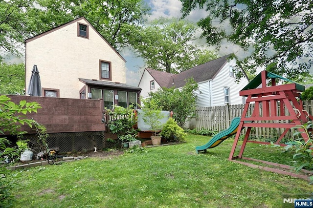 393 High St, Nutley, NJ 07110 - view of yard featuring a playground, a sunroom, and a wooden deck