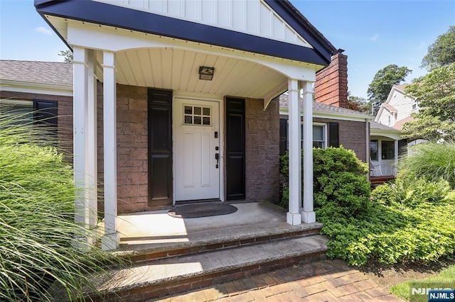 19 Mountain Rdg, Wayne, NJ 07470 - doorway to property with board and batten siding, brick siding, and a shingled roof