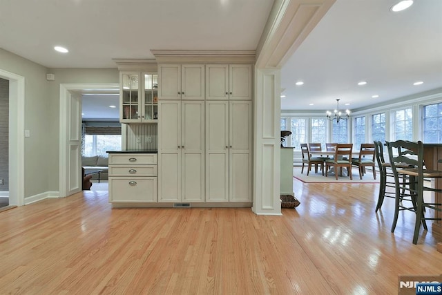 152 Highwood Ave, Tenafly, NJ 07670 - kitchen with healthy amount of natural light, light wood-type flooring, a chandelier, recessed lighting, and glass insert cabinets