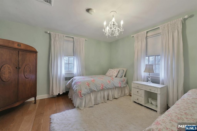 152 Highwood Ave, Tenafly, NJ 07670 - bedroom with a chandelier, multiple windows, and wood finished floors
