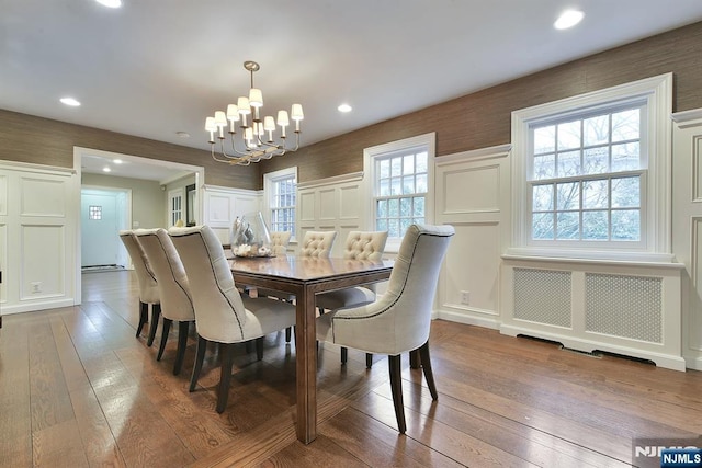 152 Highwood Ave, Tenafly, NJ 07670 - dining area with a chandelier, hardwood / wood-style floors, a decorative wall, and recessed lighting
