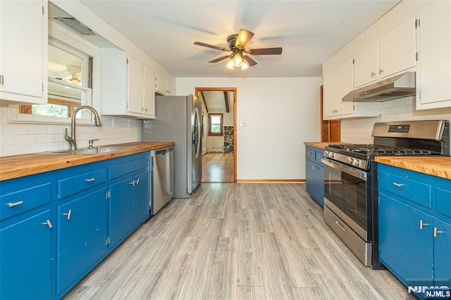 51 Lake Trl, Wayne, NJ 07470 - kitchen with stainless steel appliances, wooden counters, under cabinet range hood, and blue cabinetry
