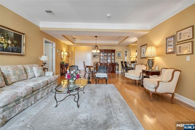 7108 Ravenscroft Rd Unit 555, Clifton, NJ 07013 - living room with light wood-style flooring, a tray ceiling, ornamental molding, and a chandelier
