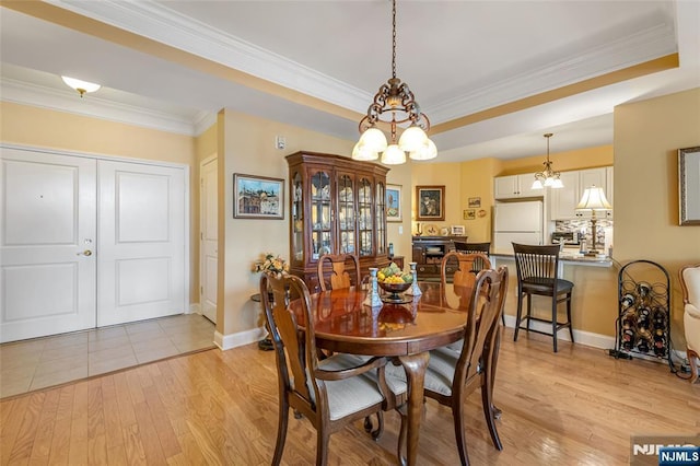 7108 Ravenscroft Rd Unit 555, Clifton, NJ 07013 - dining space featuring a chandelier, light wood-style floors, ornamental molding, and a raised ceiling
