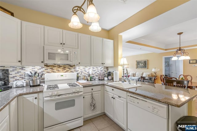 7108 Ravenscroft Rd Unit 555, Clifton, NJ 07013 - kitchen featuring white appliances, a peninsula, decorative backsplash, white cabinets, and ornamental molding