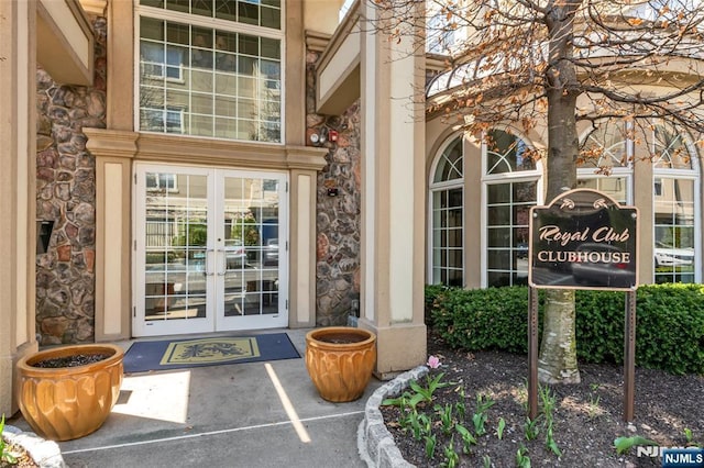 7108 Ravenscroft Rd Unit 555, Clifton, NJ 07013 - doorway to property with french doors, stone siding, and uncovered parking