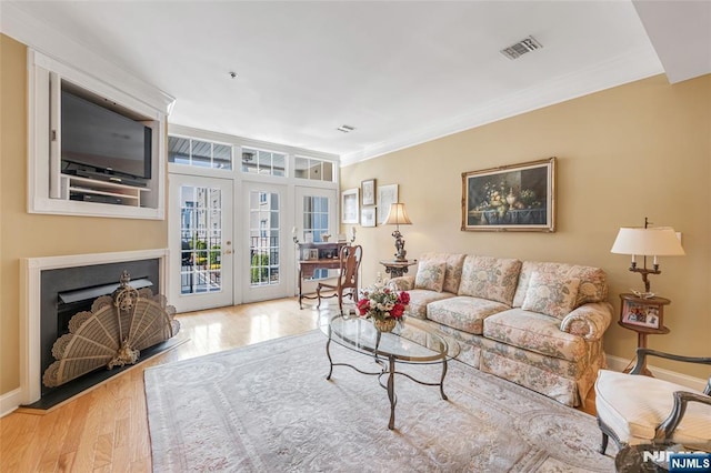 7108 Ravenscroft Rd Unit 555, Clifton, NJ 07013 - living area with wood finished floors, ornamental molding, a fireplace with flush hearth, and french doors