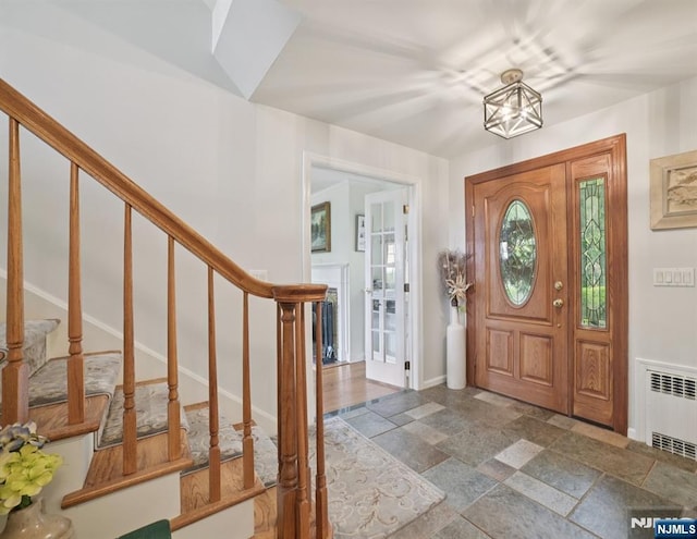6 Summit, Kinnelon Borough, NJ 07405 - entryway featuring radiator heating unit, stone tile floors, and stairs