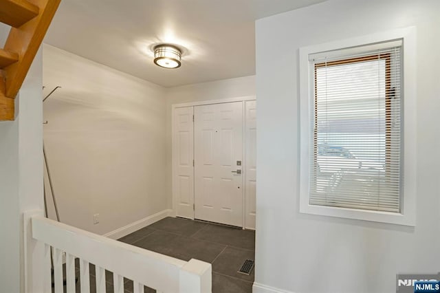 1 Columbus Pl, Cliffside Park, NJ 07010 - foyer with baseboards and dark tile patterned floors