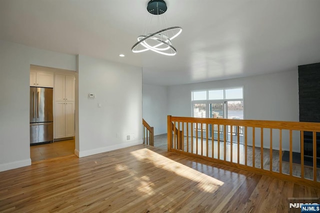 1 Columbus Pl, Cliffside Park, NJ 07010 - unfurnished room featuring a chandelier, light wood-style flooring, and recessed lighting