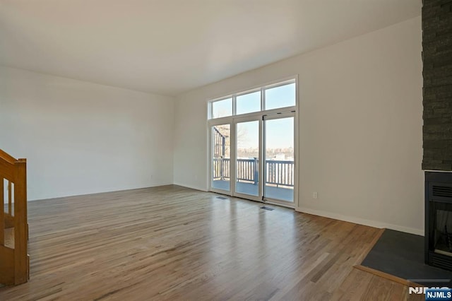 1 Columbus Pl, Cliffside Park, NJ 07010 - unfurnished living room with wood finished floors and a fireplace