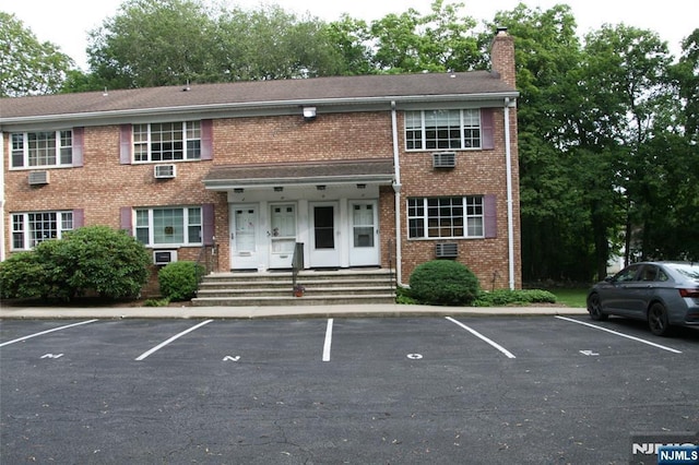 41 N Franklin Tpke Unit O, Ramsey, NJ 07446 - view of property featuring a chimney, uncovered parking, and brick siding
