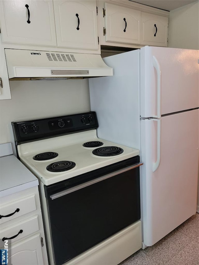 41 N Franklin Tpke Unit O, Ramsey, NJ 07446 - kitchen featuring electric range, wall chimney exhaust hood, white cabinets, freestanding refrigerator, and dark speckled floor