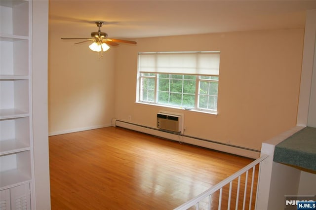 41 N Franklin Tpke Unit O, Ramsey, NJ 07446 - spare room featuring baseboard heating, a ceiling fan, wood finished floors, a wall unit AC, and built in features