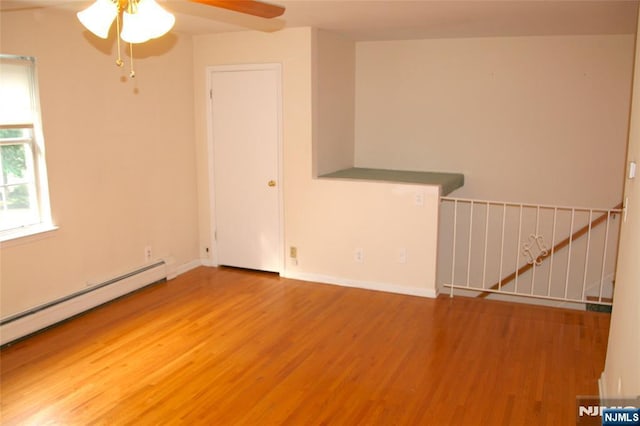 41 N Franklin Tpke Unit O, Ramsey, NJ 07446 - empty room featuring wood finished floors, ceiling fan, and a baseboard heating unit