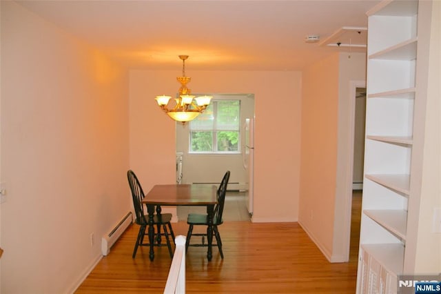 41 N Franklin Tpke Unit O, Ramsey, NJ 07446 - dining area featuring baseboard heating, light wood-style flooring, and a chandelier