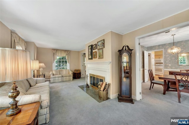 486 Summit Ave, Oradell, NJ 07649 - living room with carpet, a fireplace with flush hearth, a chandelier, wallpapered walls, and a baseboard radiator