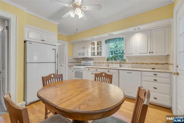 486 Summit Ave, Oradell, NJ 07649 - kitchen with white appliances, light wood finished floors, decorative backsplash, white cabinets, and crown molding