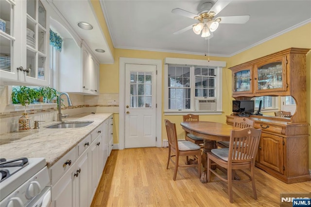 486 Summit Ave, Oradell, NJ 07649 - kitchen with white range with gas stovetop, ceiling fan, cooling unit, glass insert cabinets, and light wood-style floors