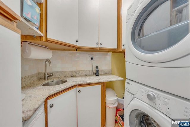 486 Summit Ave, Oradell, NJ 07649 - washroom featuring stacked washing machine and dryer and cabinet space