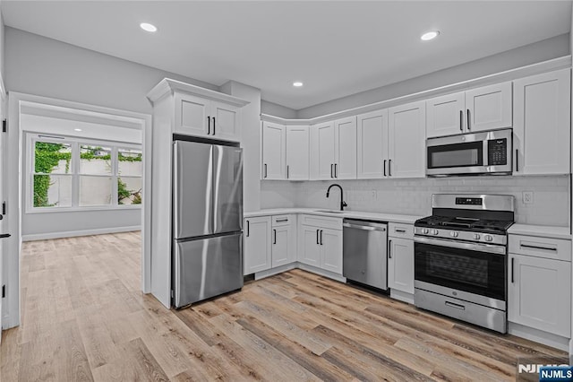 6 Pleasant Ave, Clifton, NJ 07013 - kitchen featuring stainless steel appliances, light countertops, white cabinets, decorative backsplash, and recessed lighting