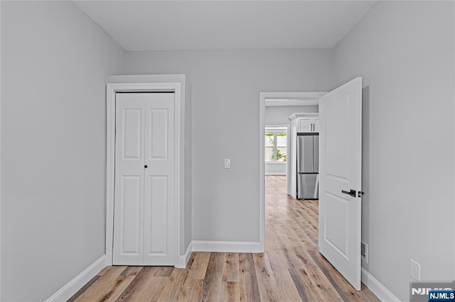 6 Pleasant Ave, Clifton, NJ 07013 - unfurnished bedroom featuring freestanding refrigerator, light wood-style flooring, and a closet