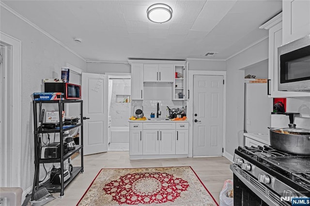 6 Pleasant Ave, Clifton, NJ 07013 - kitchen with stainless steel appliances, crown molding, white cabinetry, tasteful backsplash, and light countertops