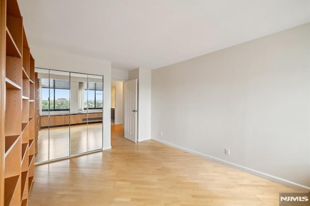 300 Winston Unit 1822, Cliffside Park, NJ 07010 - unfurnished living room featuring baseboards and light wood-type flooring
