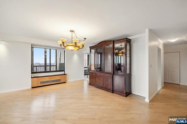 300 Winston Unit 1822, Cliffside Park, NJ 07010 - unfurnished dining area featuring a chandelier, light wood-type flooring, and radiator