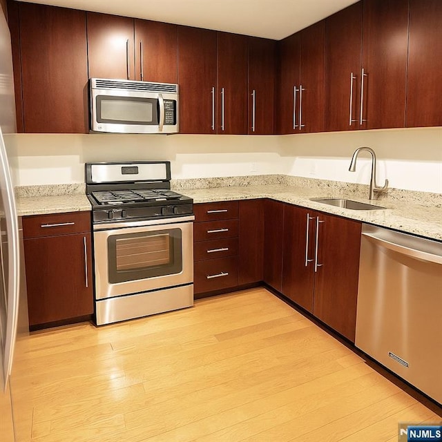 917 Hudson Park, Edgewater, NJ 07020 - kitchen featuring stainless steel appliances, light stone countertops, light wood-type flooring, and modern cabinets