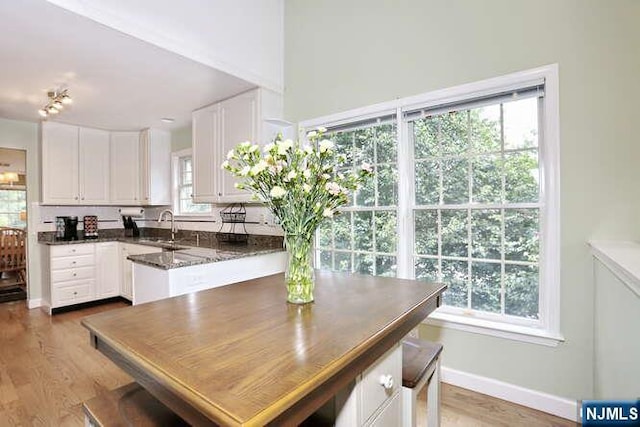 84 Pheasant Run Unit 84, Old Tappan, NJ 07675 - kitchen featuring white cabinetry, light wood-style flooring, and dark stone countertops