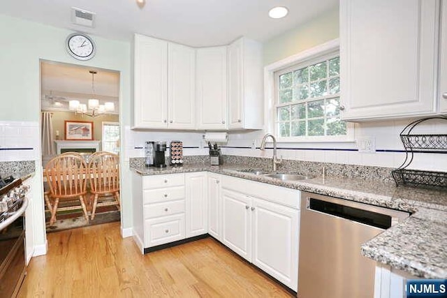 84 Pheasant Run Unit 84, Old Tappan, NJ 07675 - kitchen featuring stainless steel appliances, light wood-type flooring, white cabinetry, light stone counters, and recessed lighting