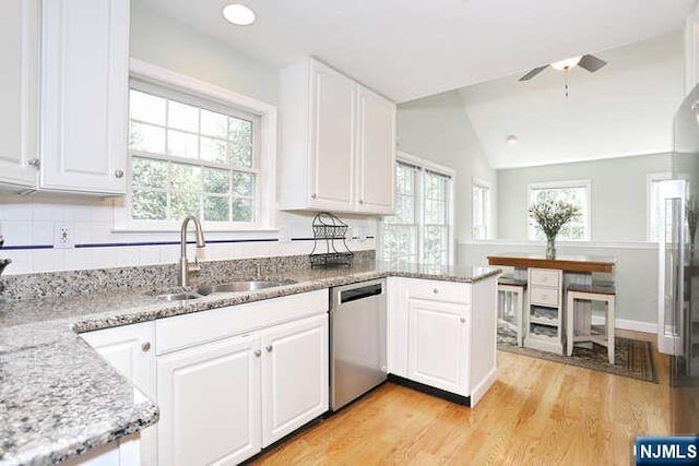 84 Pheasant Run Unit 84, Old Tappan, NJ 07675 - kitchen featuring stainless steel dishwasher, white cabinetry, plenty of natural light, and vaulted ceiling