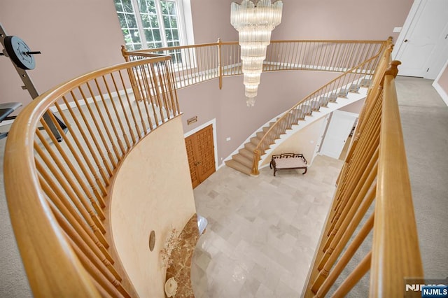 326 Ridge Rd, Cedar Grove, NJ 07009 - staircase with a chandelier, a towering ceiling, and carpet floors