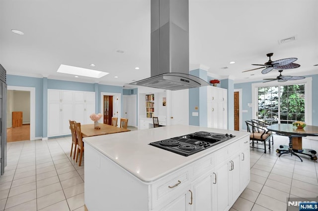 326 Ridge Rd, Cedar Grove, NJ 07009 - kitchen with black electric cooktop, island exhaust hood, recessed lighting, light tile patterned floors, and a kitchen island