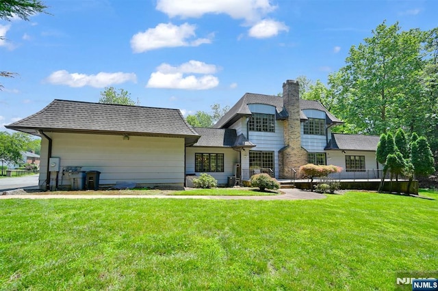 326 Ridge Rd, Cedar Grove, NJ 07009 - view of front facade with a front yard and a chimney