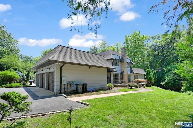 326 Ridge Rd, Cedar Grove, NJ 07009 - back of property featuring a chimney, a yard, a garage, and roof with shingles