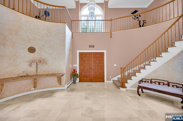 326 Ridge Rd, Cedar Grove, NJ 07009 - entrance foyer with stairs, a towering ceiling, a chandelier, and a baseboard heating unit
