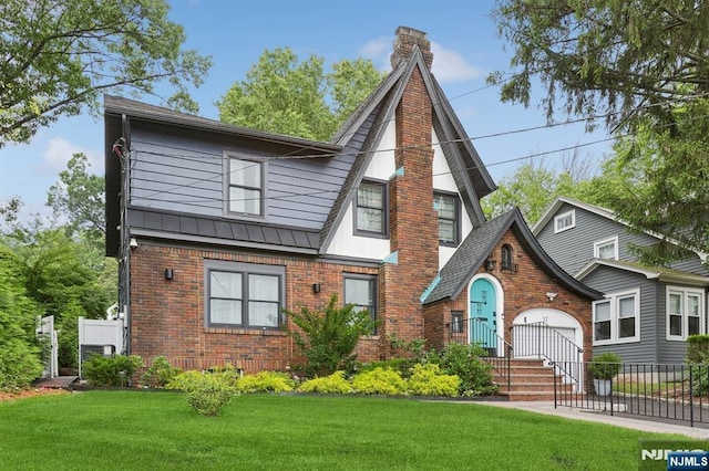 17 Lowell Ave, West Orange, NJ 07052 - tudor house featuring brick siding, a chimney, an attached garage, and a standing seam roof