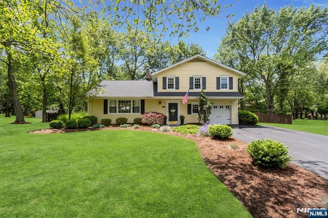 611 Maze Rd, River Vale, NJ 07675 - traditional-style home featuring asphalt driveway, an attached garage, and roof with shingles