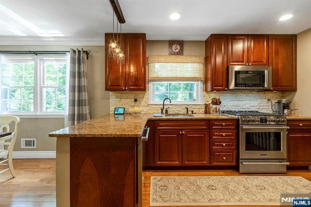 611 Maze Rd, River Vale, NJ 07675 - kitchen with stainless steel appliances, plenty of natural light, light stone counters, tasteful backsplash, and crown molding