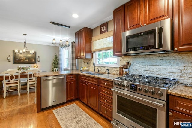 611 Maze Rd, River Vale, NJ 07675 - kitchen with stainless steel appliances, a peninsula, light stone countertops, decorative backsplash, and light wood finished floors