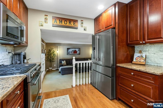 611 Maze Rd, River Vale, NJ 07675 - kitchen with high end appliances, light wood-type flooring, backsplash, light stone countertops, and recessed lighting