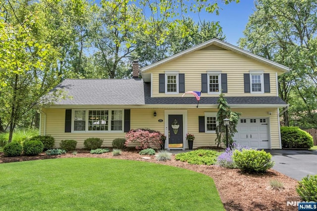 611 Maze Rd, River Vale, NJ 07675 - traditional-style house featuring a garage, asphalt driveway, a front lawn, and a chimney