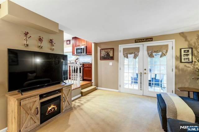 611 Maze Rd, River Vale, NJ 07675 - living area featuring light colored carpet, plenty of natural light, french doors, and a glass covered fireplace