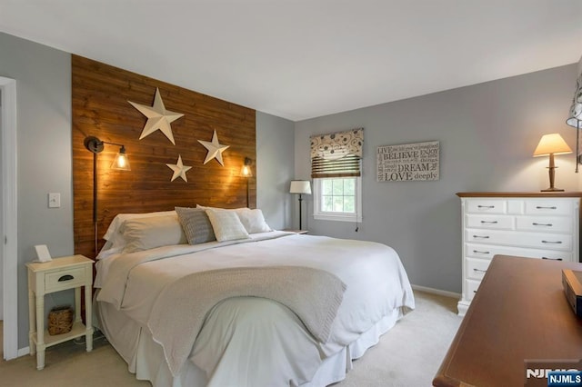 611 Maze Rd, River Vale, NJ 07675 - bedroom featuring an accent wall, wood walls, and light colored carpet