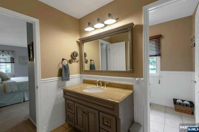 611 Maze Rd, River Vale, NJ 07675 - ensuite bathroom with wainscoting, healthy amount of natural light, vanity, and tile patterned floors