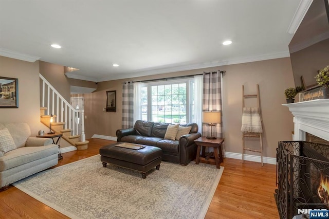 611 Maze Rd, River Vale, NJ 07675 - living room with light wood-style flooring, stairway, recessed lighting, ornamental molding, and a lit fireplace